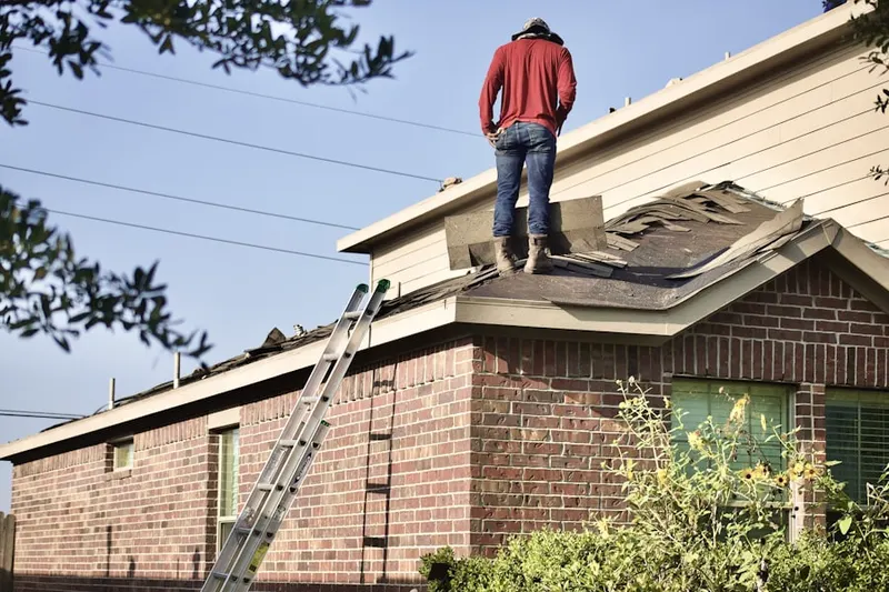 Professional roofer working on a residential roof in Flicksville